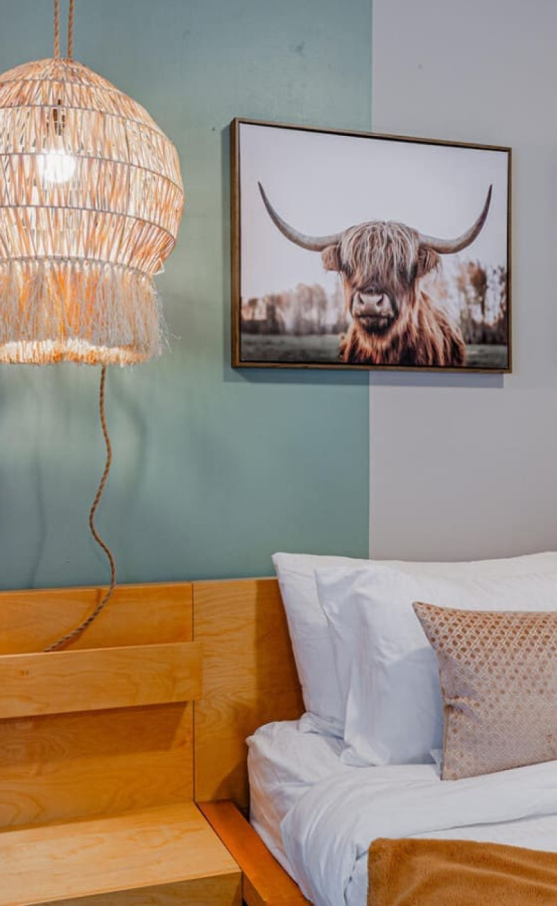 Settle into the cozy king bed after a day of city adventures, surrounded by soft lighting and natural textures that create a peaceful, restful ambiance.